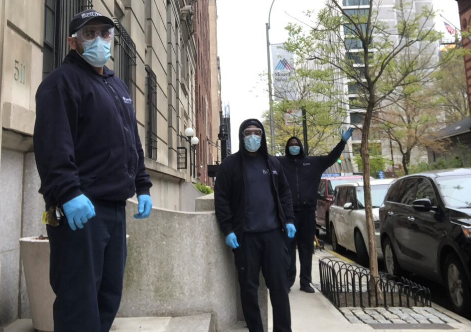 three men with masks in front of residential building