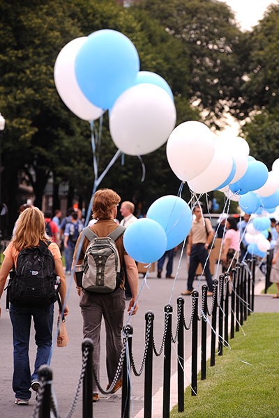 Students walking near blue and white balloon on College Walk