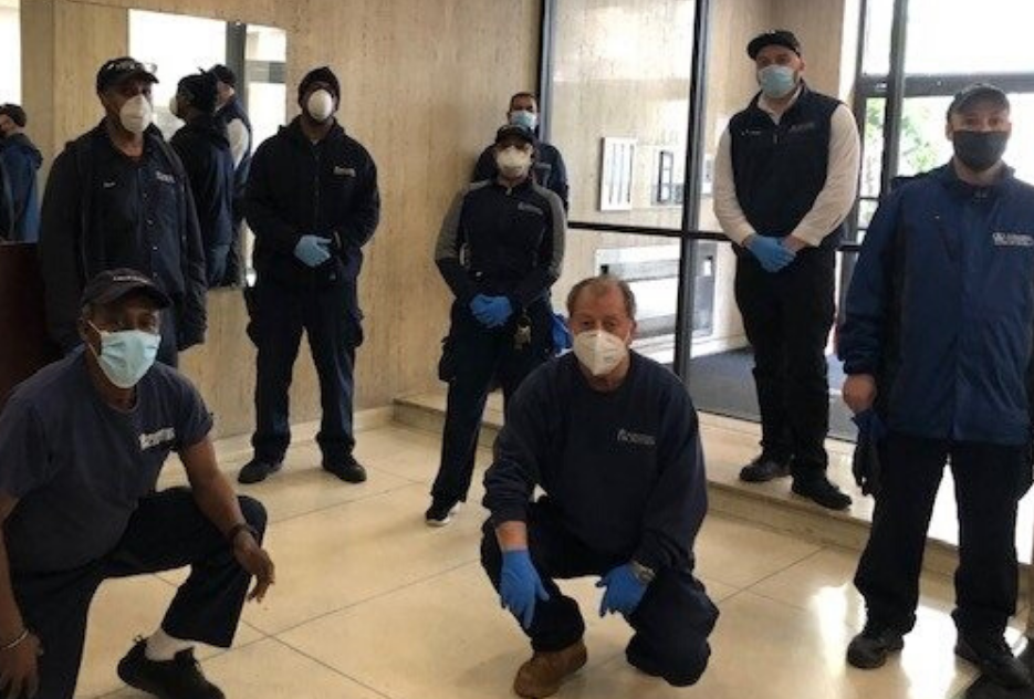 eight residential staff members with masks in building lobby
