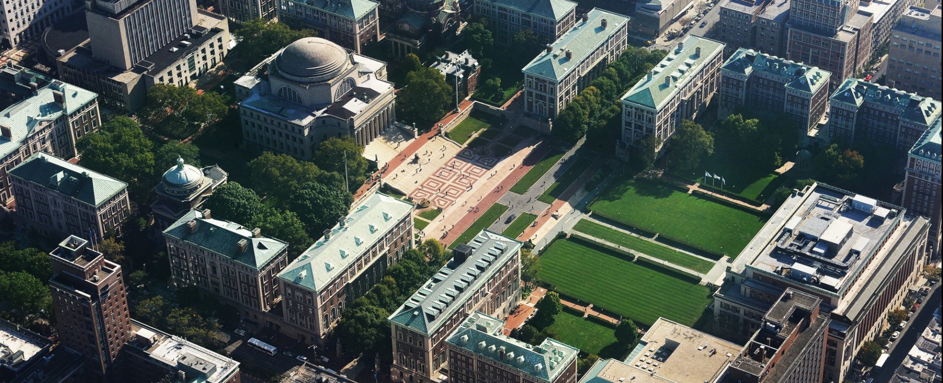 Aerial photo of Columbia's campus with Low Library and college walk at the center.