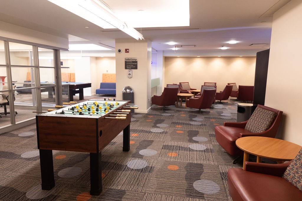 View of building lounge showing foosball table, pool table and lounge seating