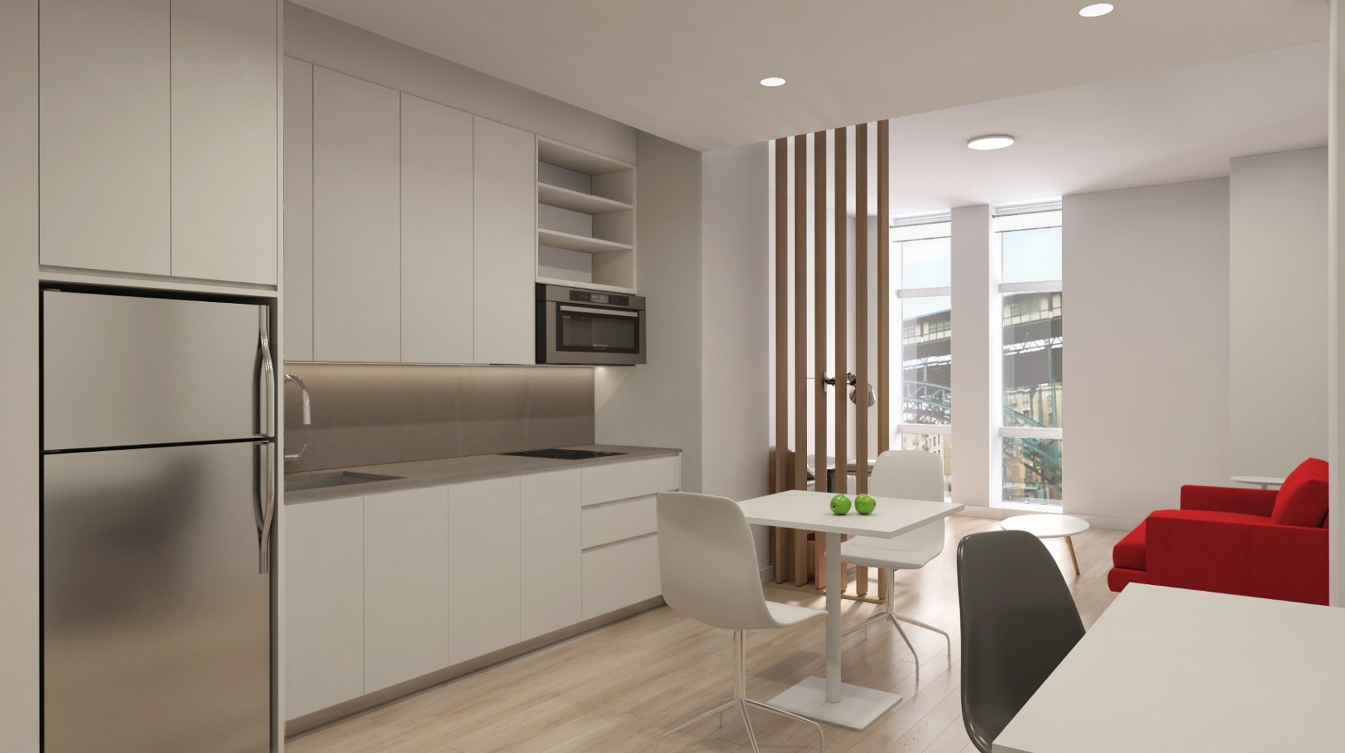A rendering of a studio unit for graduate students at 600 W. 125th Street. A rendering of a studio unit for graduate students with white cabinetry in the kitchen, a red sofa, a wood dividing wall, and white tables.