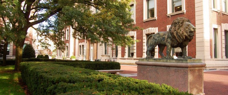 View of statue of lion in front of Havemeyer Hall and lawn
