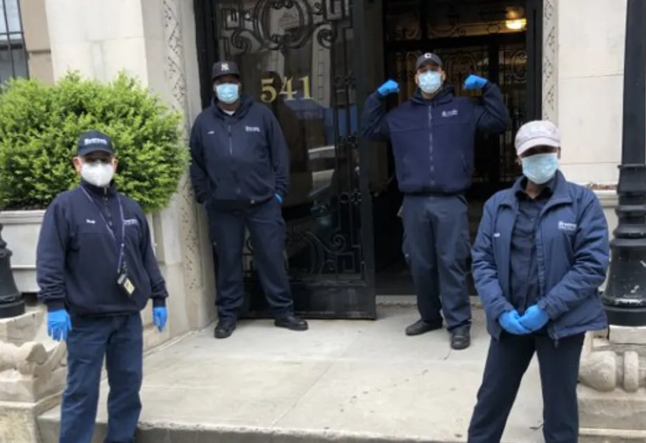 four men with masks in front of residential building