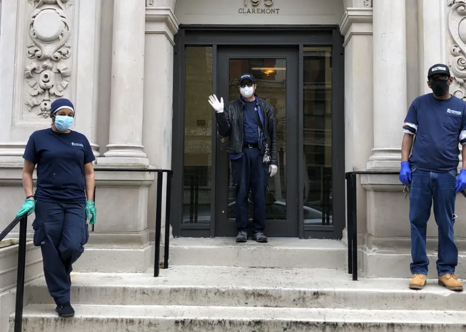 three men with masks in front of residential building