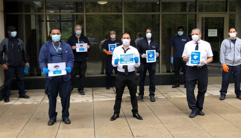 nine men with face masks in front of residential building