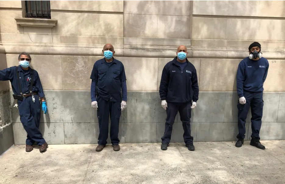 four men with masks in front of residential building