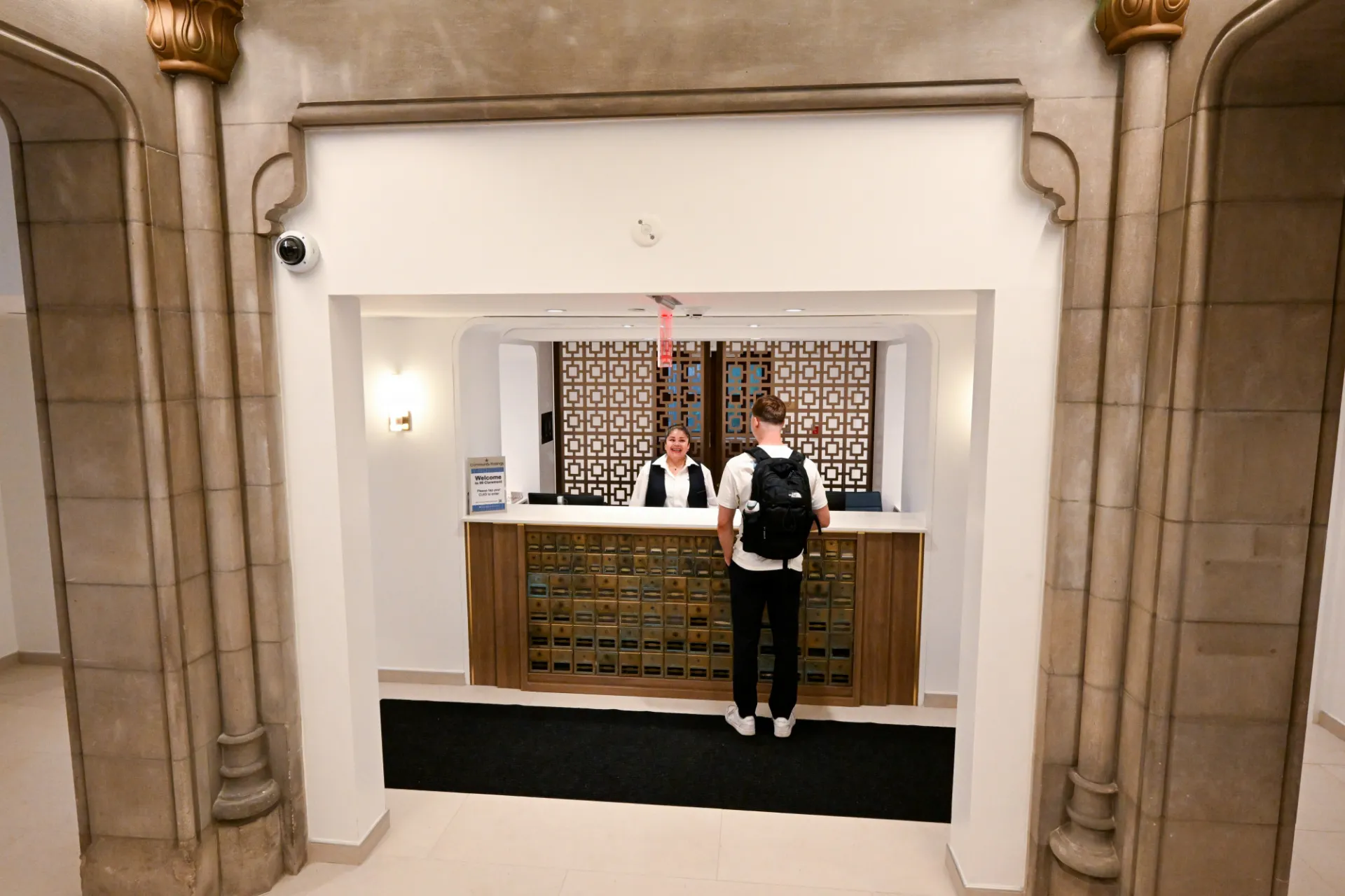 Lobby entrance with door attendant and student. Credit: Diane Bondareff