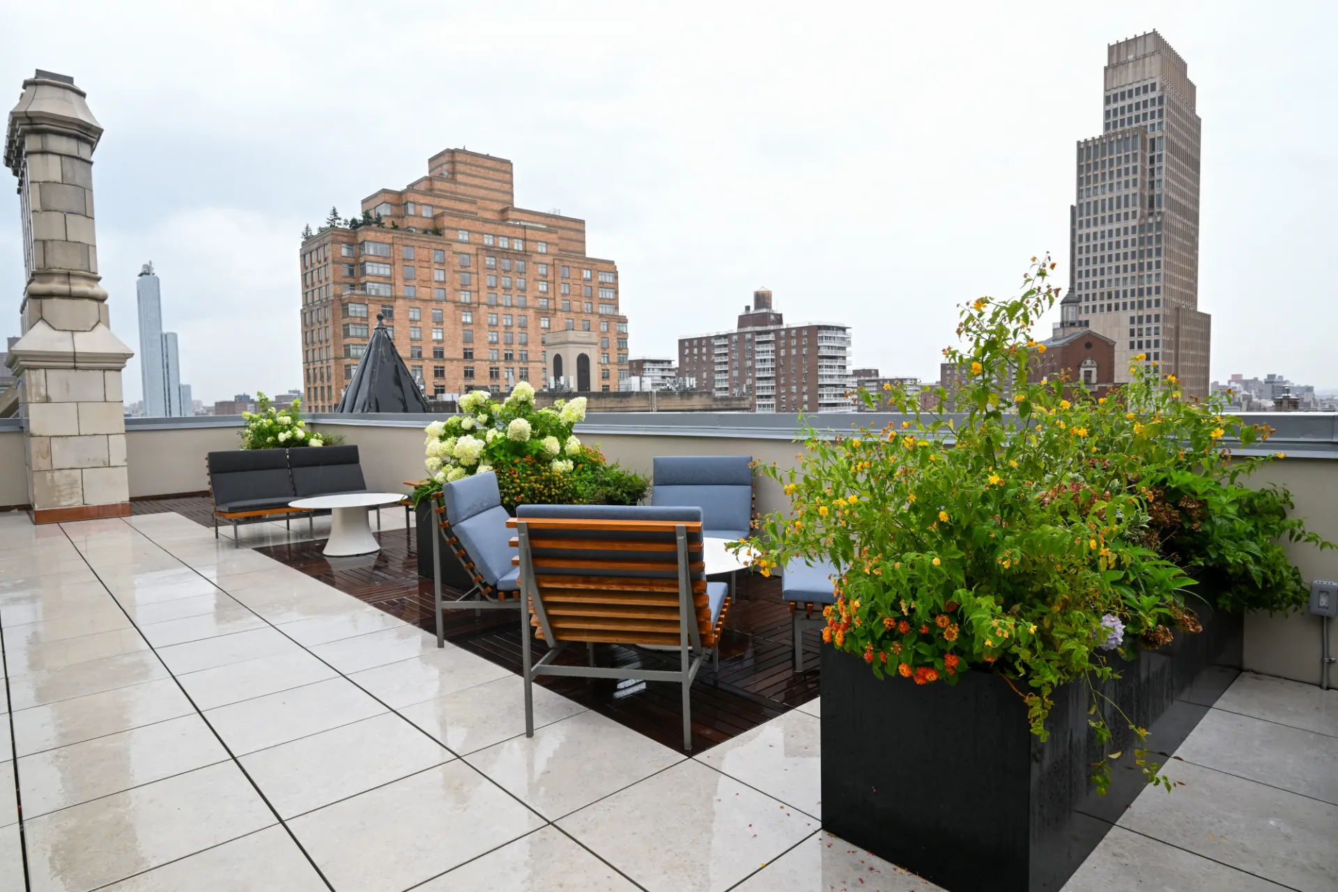 Roofdeck lounge seating and plants, facing north, with buildings in background. Credit: Diane Bondareff